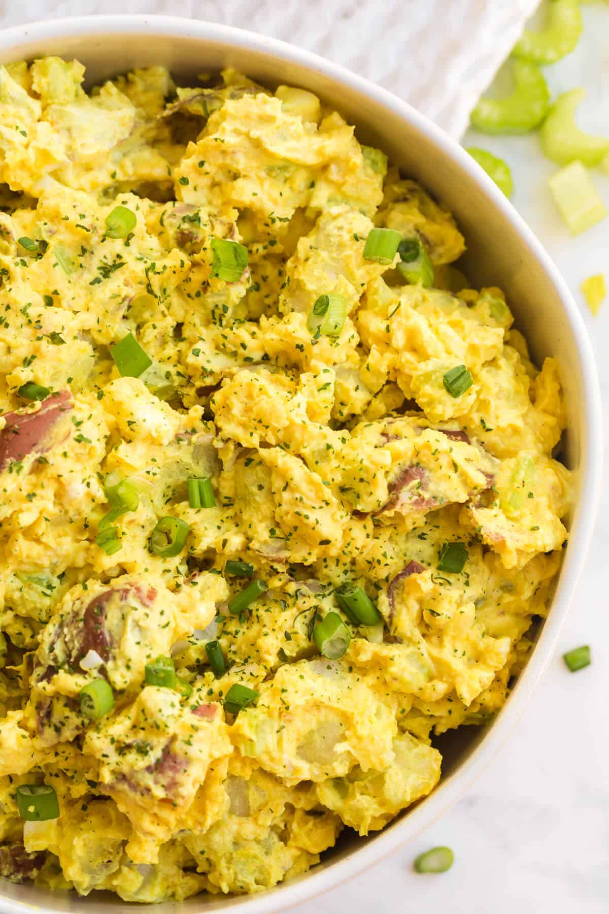 Close up of curried potato salad in a bowl.