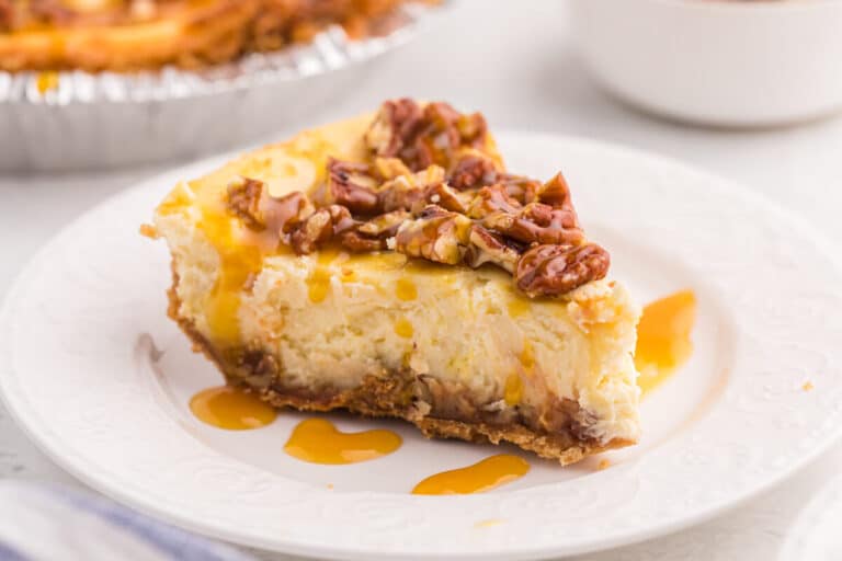 A slice of caramel pecan cheesecake on a plate.