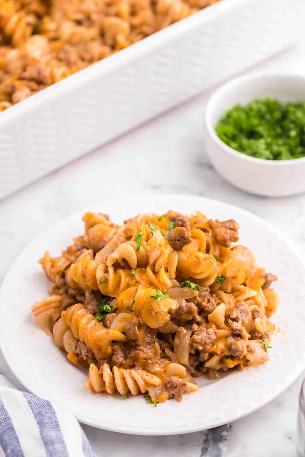 Cheesy BBQ Beef Casserole - Ground beef, cheese and tangy BBQ sauce create a quick, easy and cost-effective family meal that everyone is sure to enjoy. This dish is a great make-ahead meal, and makes a great lunch the next day!