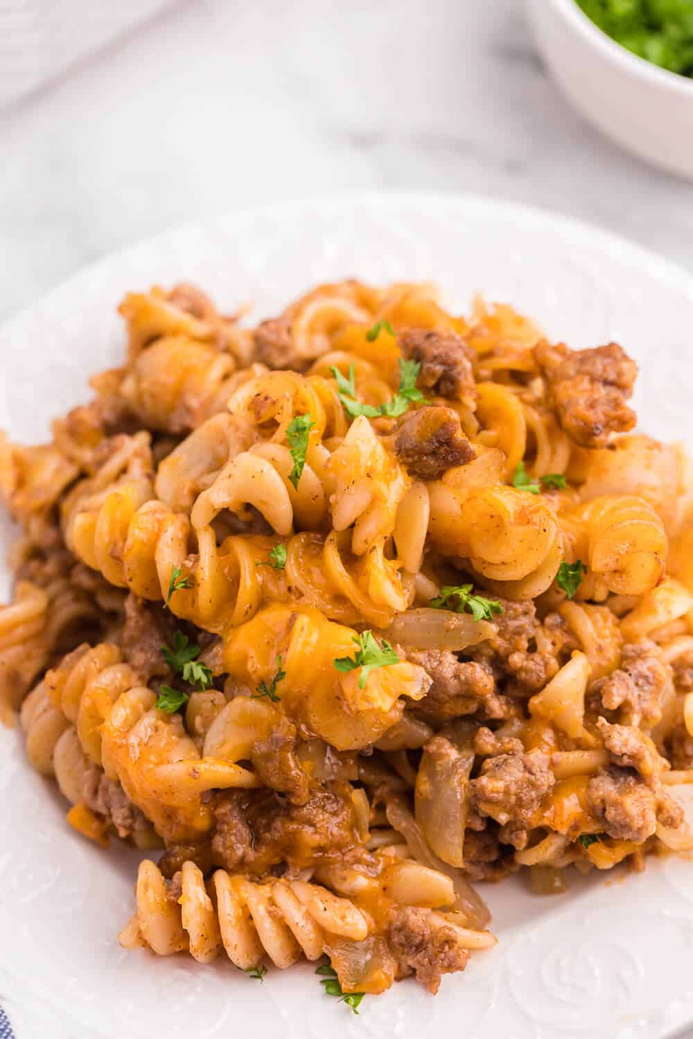 Cheesy BBQ Beef Casserole - Ground beef, cheese and tangy BBQ sauce create a quick, easy and cost-effective family meal that everyone is sure to enjoy. This dish is a great make-ahead meal, and makes a great lunch the next day!