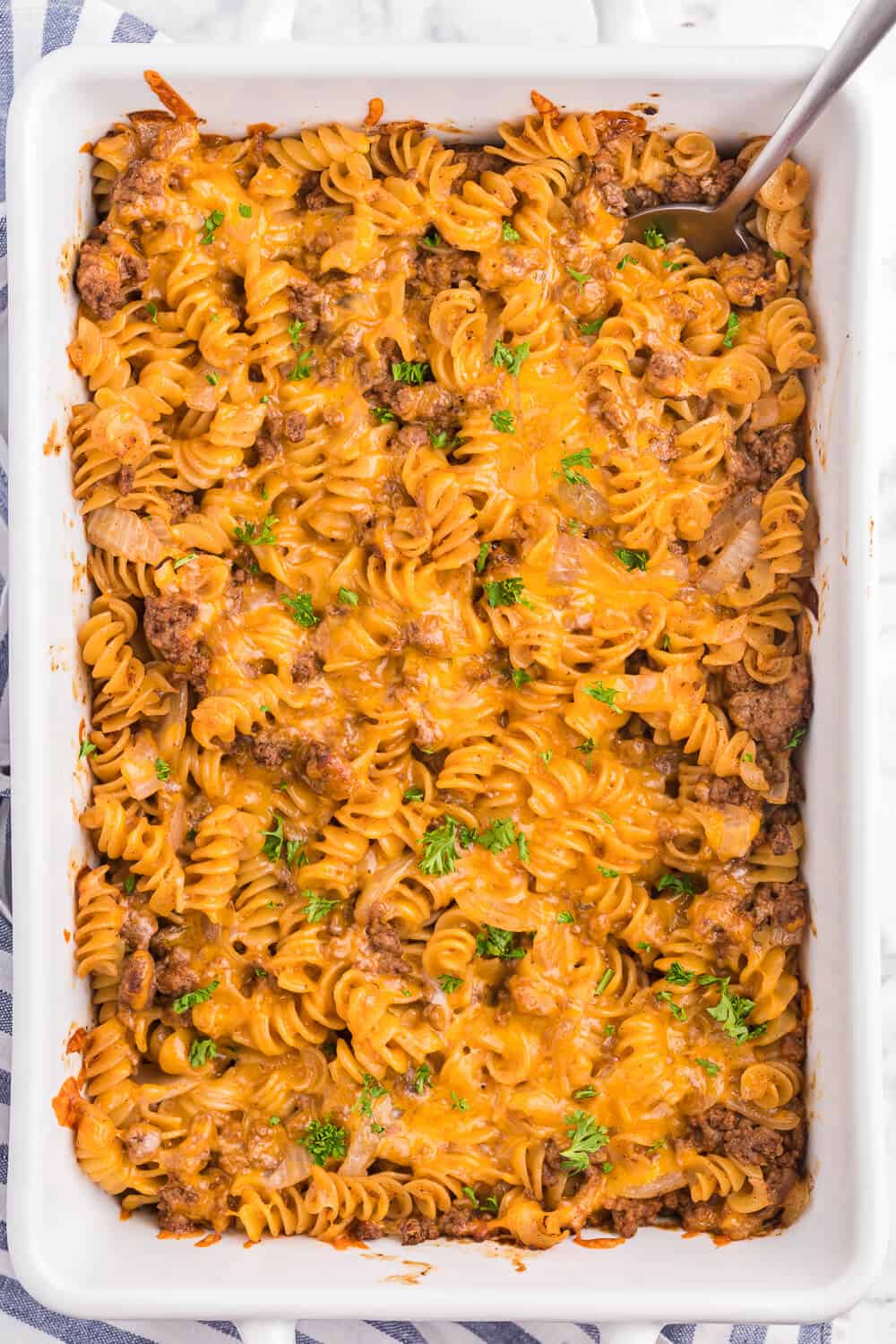 Cheesy BBQ Beef Casserole - Ground beef, cheese and tangy BBQ sauce create a quick, easy and cost-effective family meal that everyone is sure to enjoy. This dish is a great make-ahead meal, and makes a great lunch the next day!