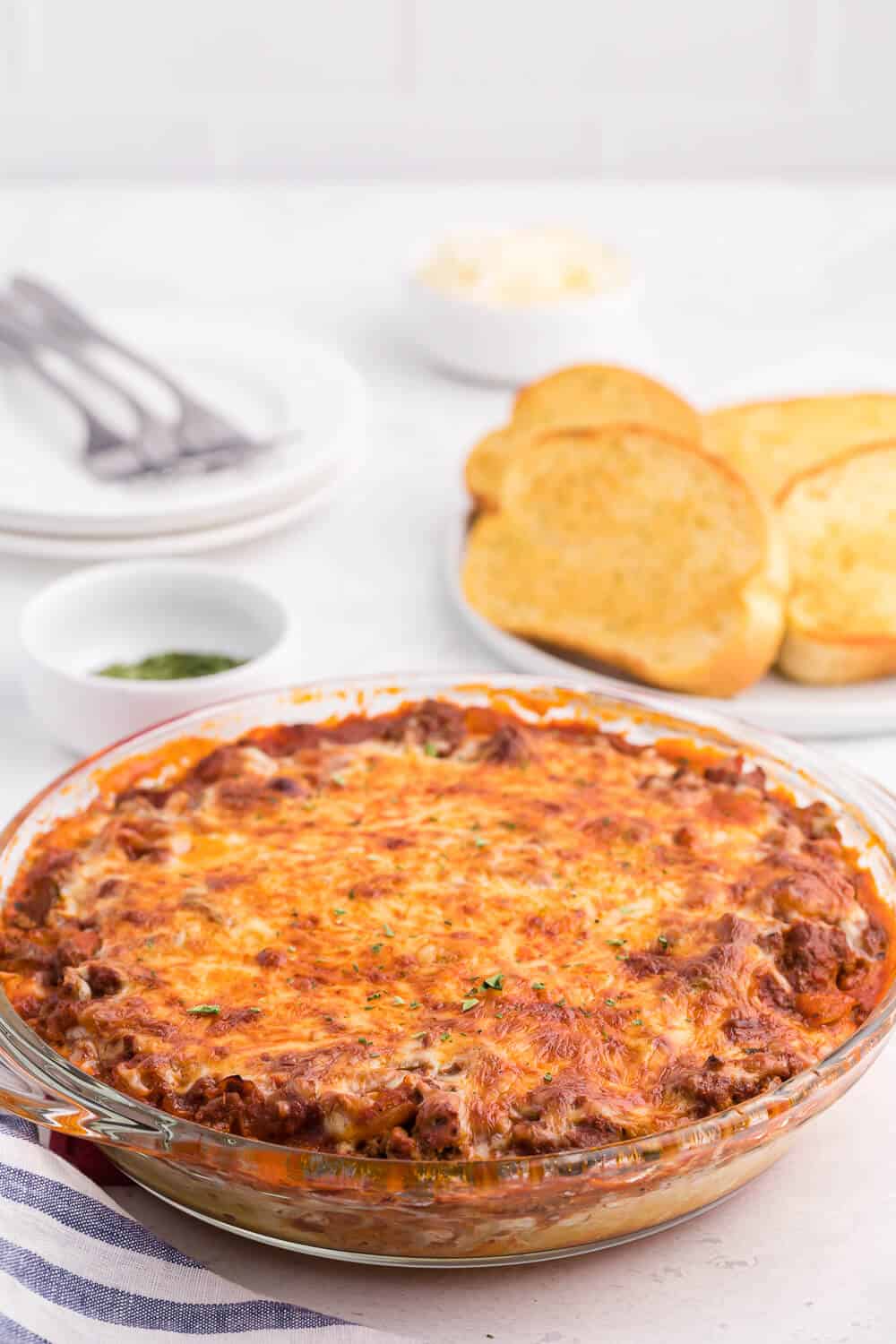 Spaghetti Pie - Lasagna + spaghetti = a big family hit! Using simple pantry ingredients, along with ground beef, and chili powder, this is a delicious crowd-pleasing meal.