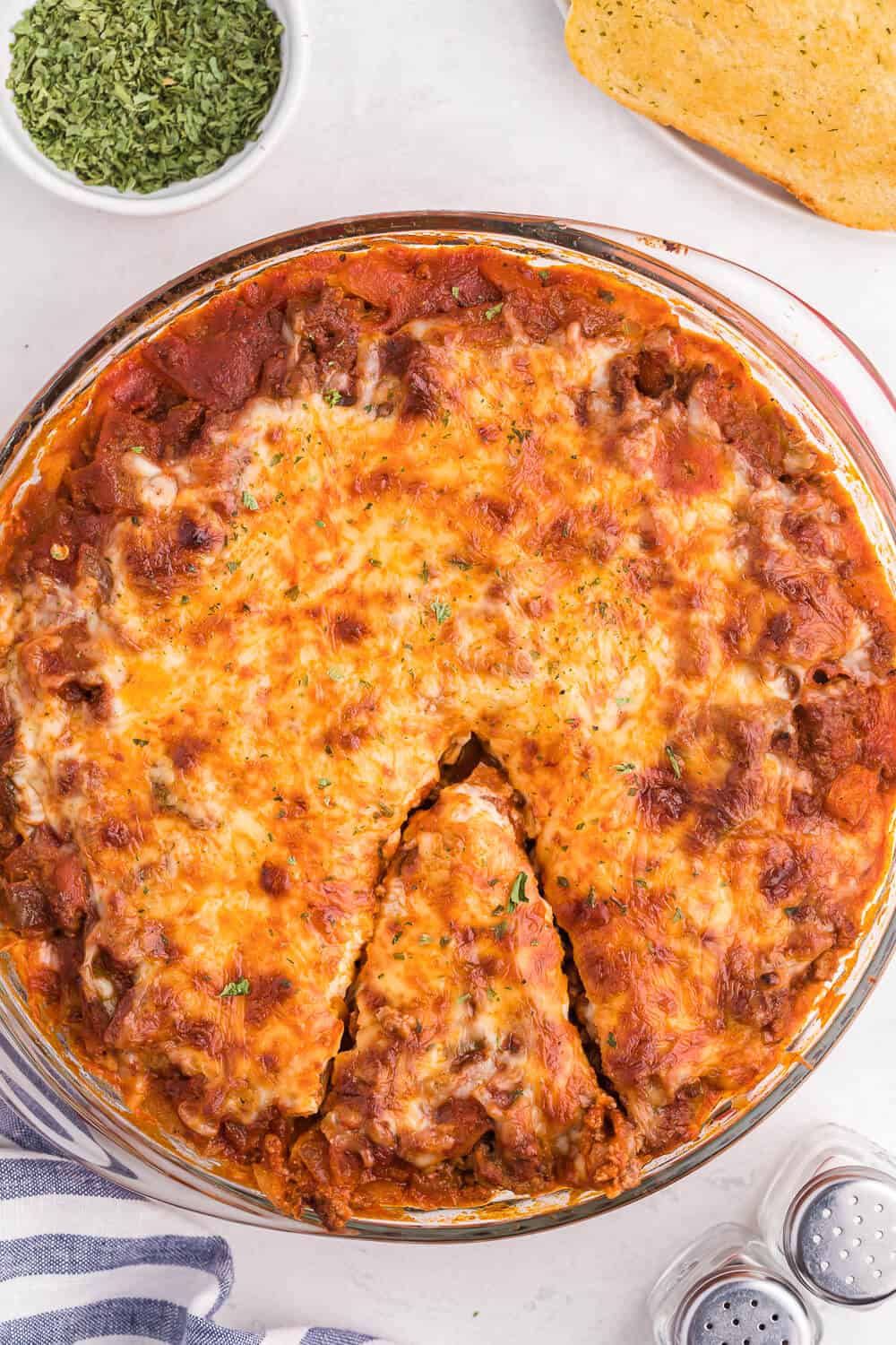 Spaghetti Pie - Lasagna + spaghetti = a big family hit! Using simple pantry ingredients, along with ground beef, and chili powder, this is a delicious crowd-pleasing meal.