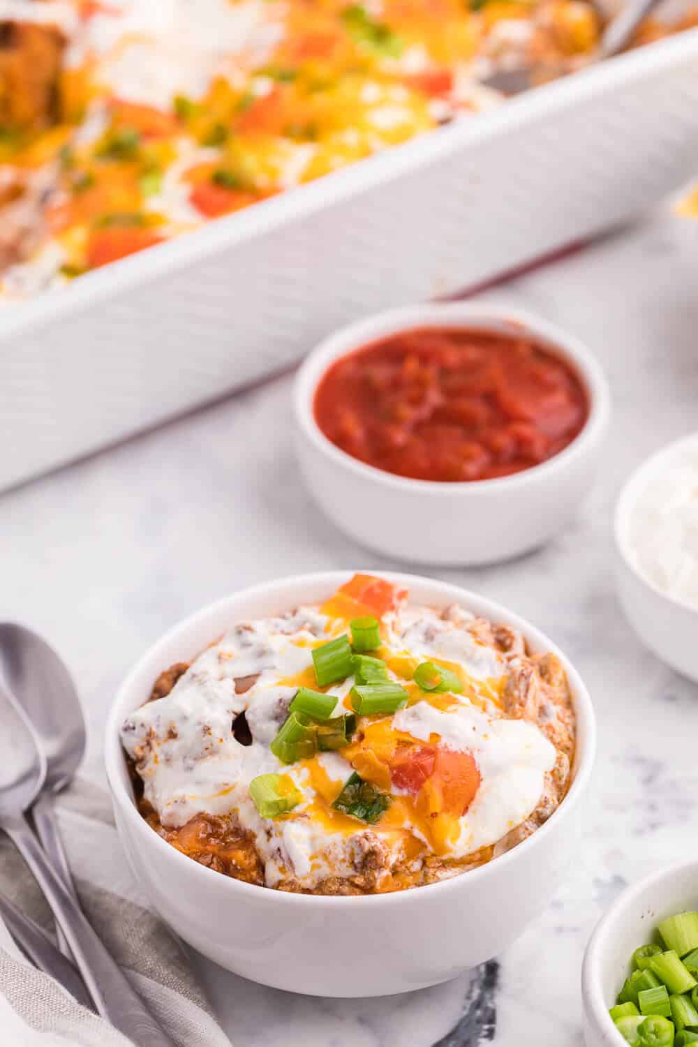 Taco Casserole - A fun twist on Taco Tuesday! This easy casserole has all the ingredients we love about tacos, baked together in one convenient baking dish - quick to make and quick to clean up!