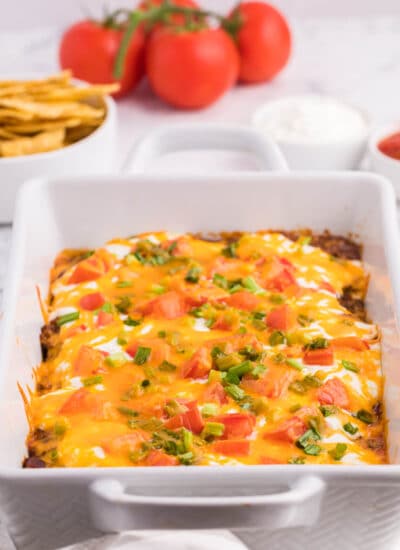 Taco casserole in a white casserole dish.