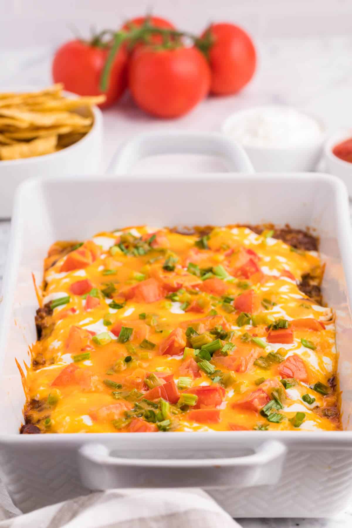 Taco casserole in a white casserole dish.