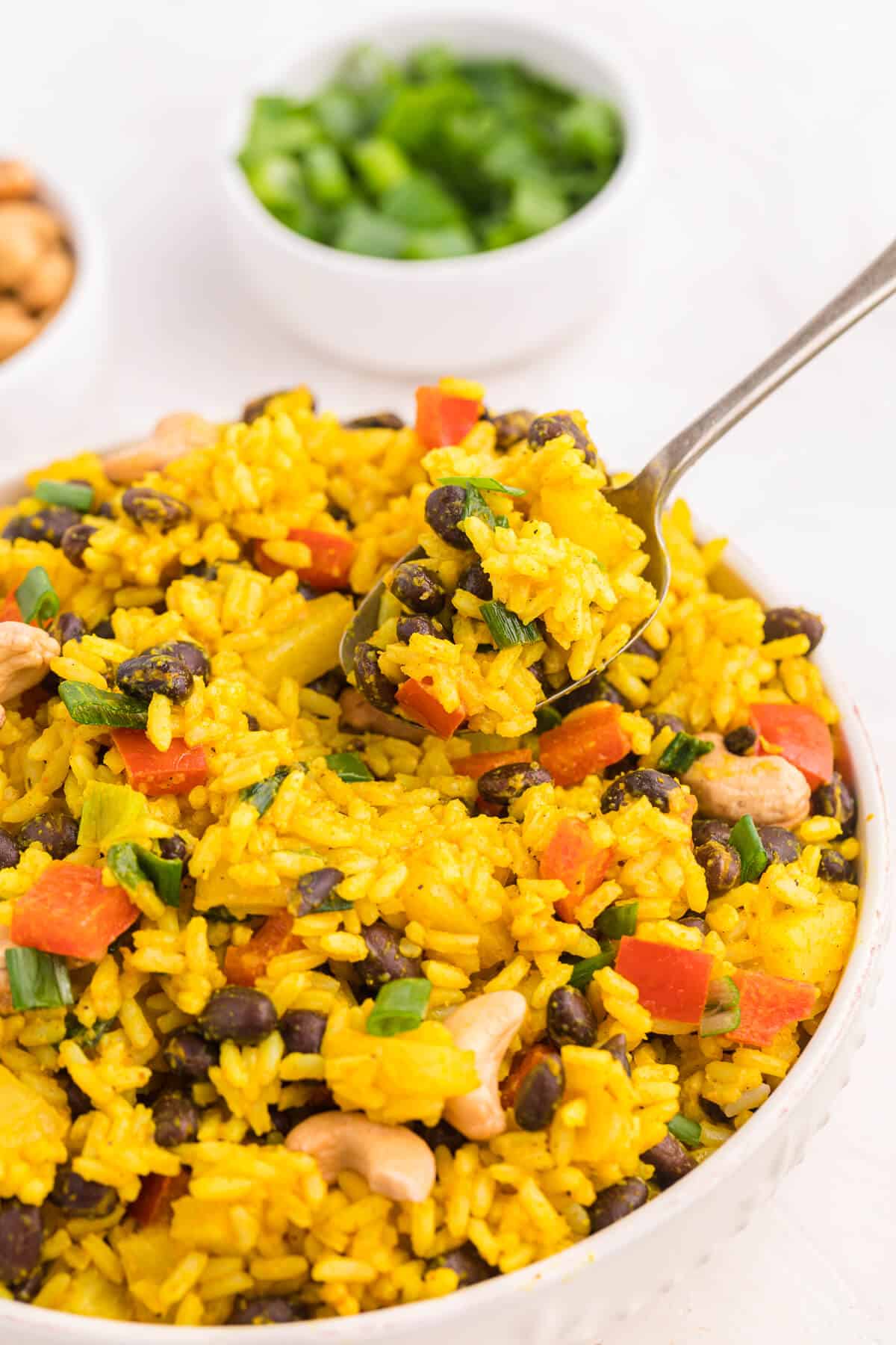 A spoon in a bowl of Jamaican Curried Rice.