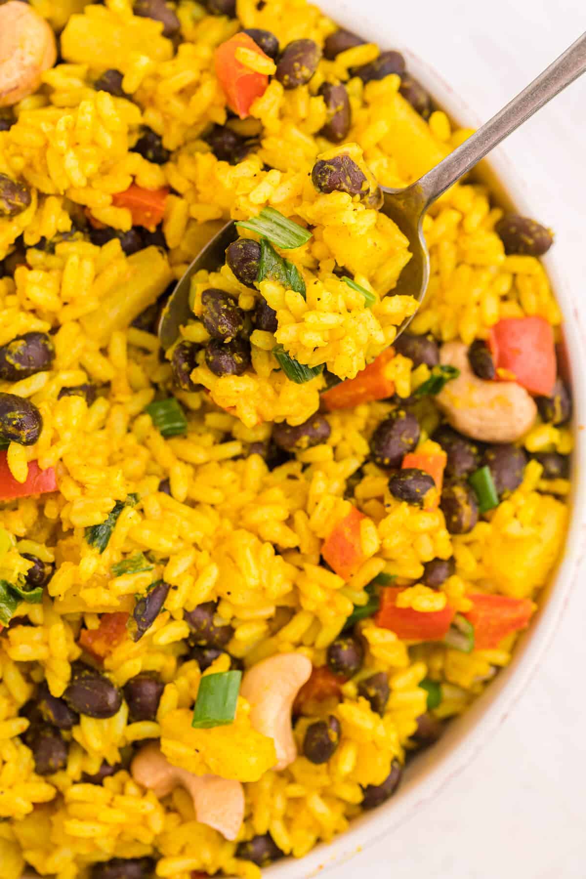 A spoon in a bowl of Jamaican curried rice.