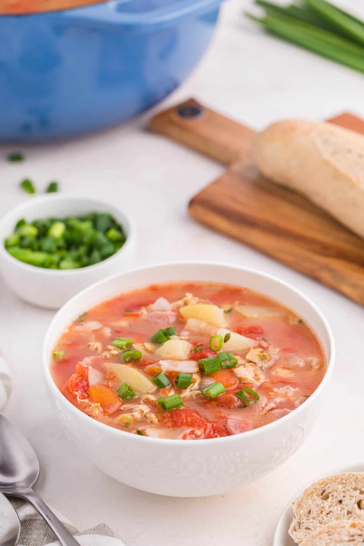 A white bowl of the soup on a counter.