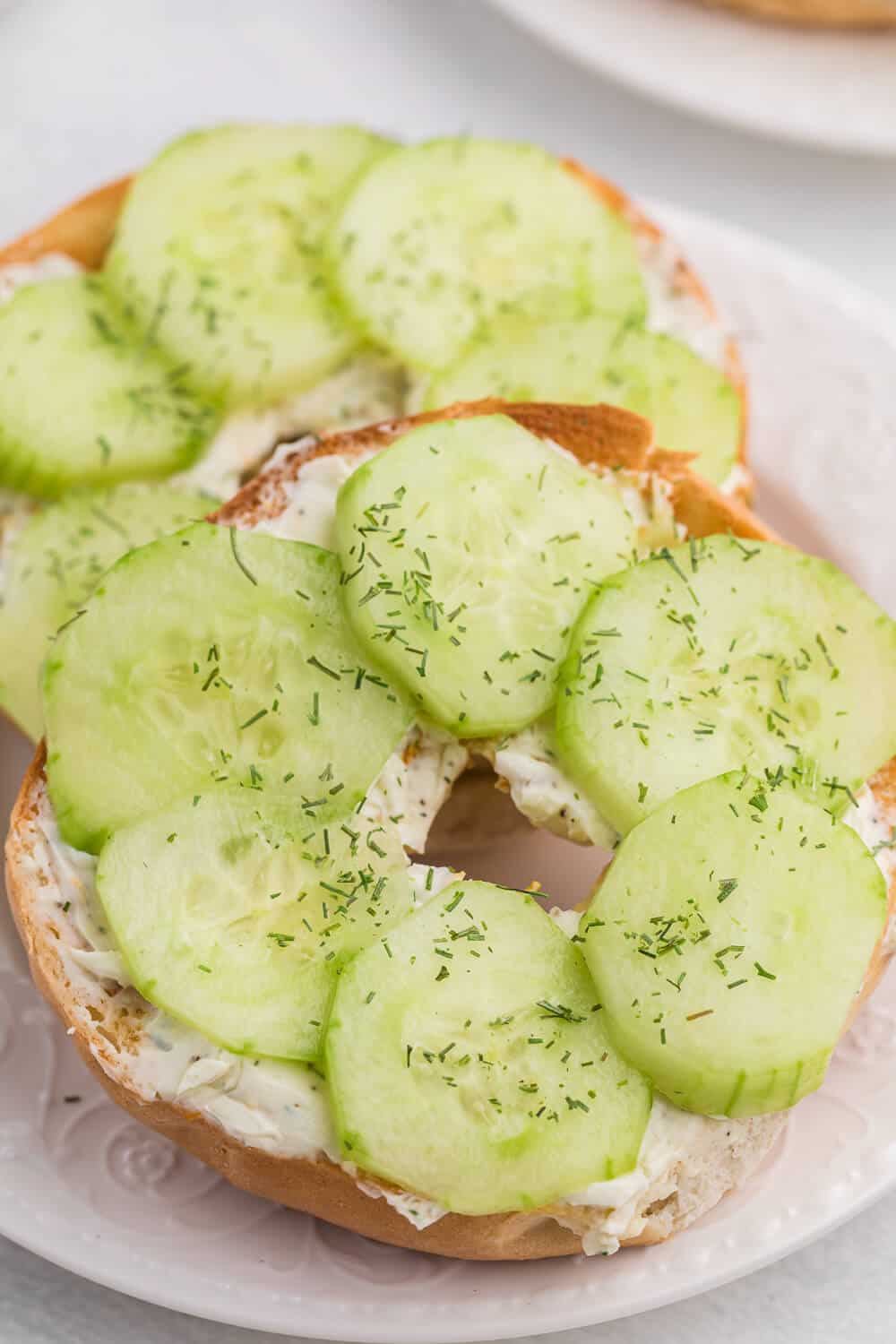 Dilly bagel served on a white plate.