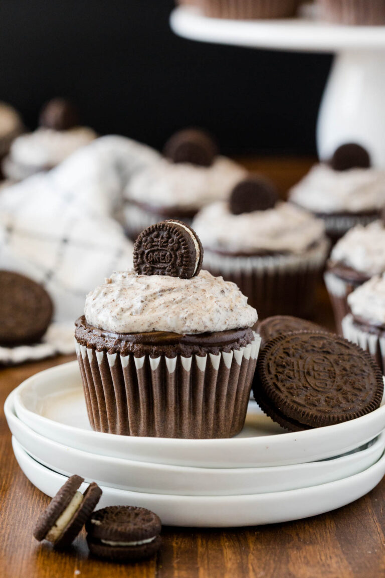 A cupcake and cookies on a plate.