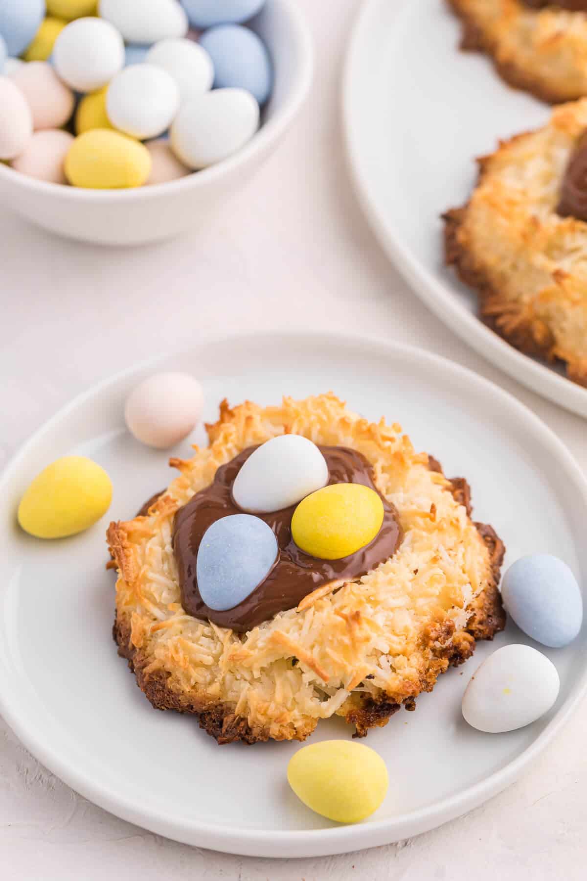 A coconut macaroon nutella cookie nest on a small plate.