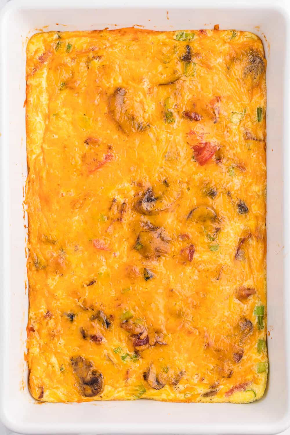Crustless Bacon and Cheese Quiche - Rich, creamy eggs with bacon and cheese are a fantastic, lower carb option for brunch or dinner. Served with fruit or mixed greens, this is delicious and satisfying, no matter what time of day you make it!