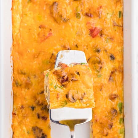 Crustless Bacon and Cheese Quiche - Rich, creamy eggs with bacon and cheese are a fantastic, lower carb option for brunch or dinner. Served with fruit or mixed greens, this is delicious and satisfying, no matter what time of day you make it!