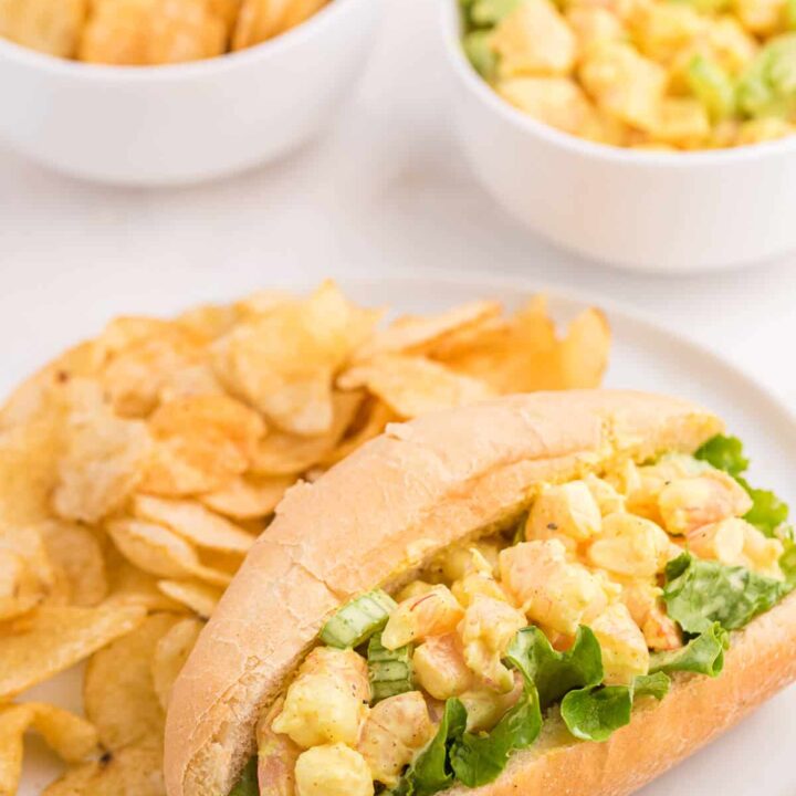 Curried Shrimp Rolls on a plate with potato chips.