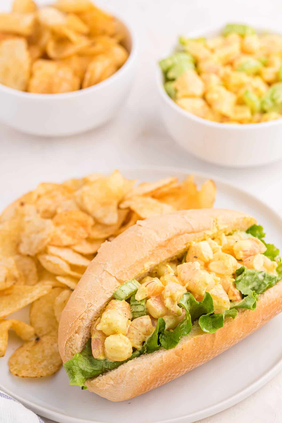 Curried Shrimp Rolls on a plate with potato chips.