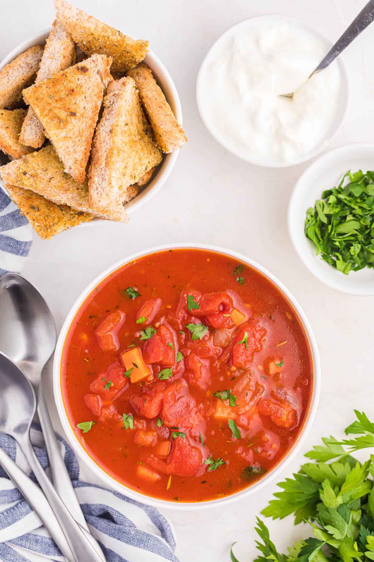 Italian herb soup in a bowl with garlic toast.