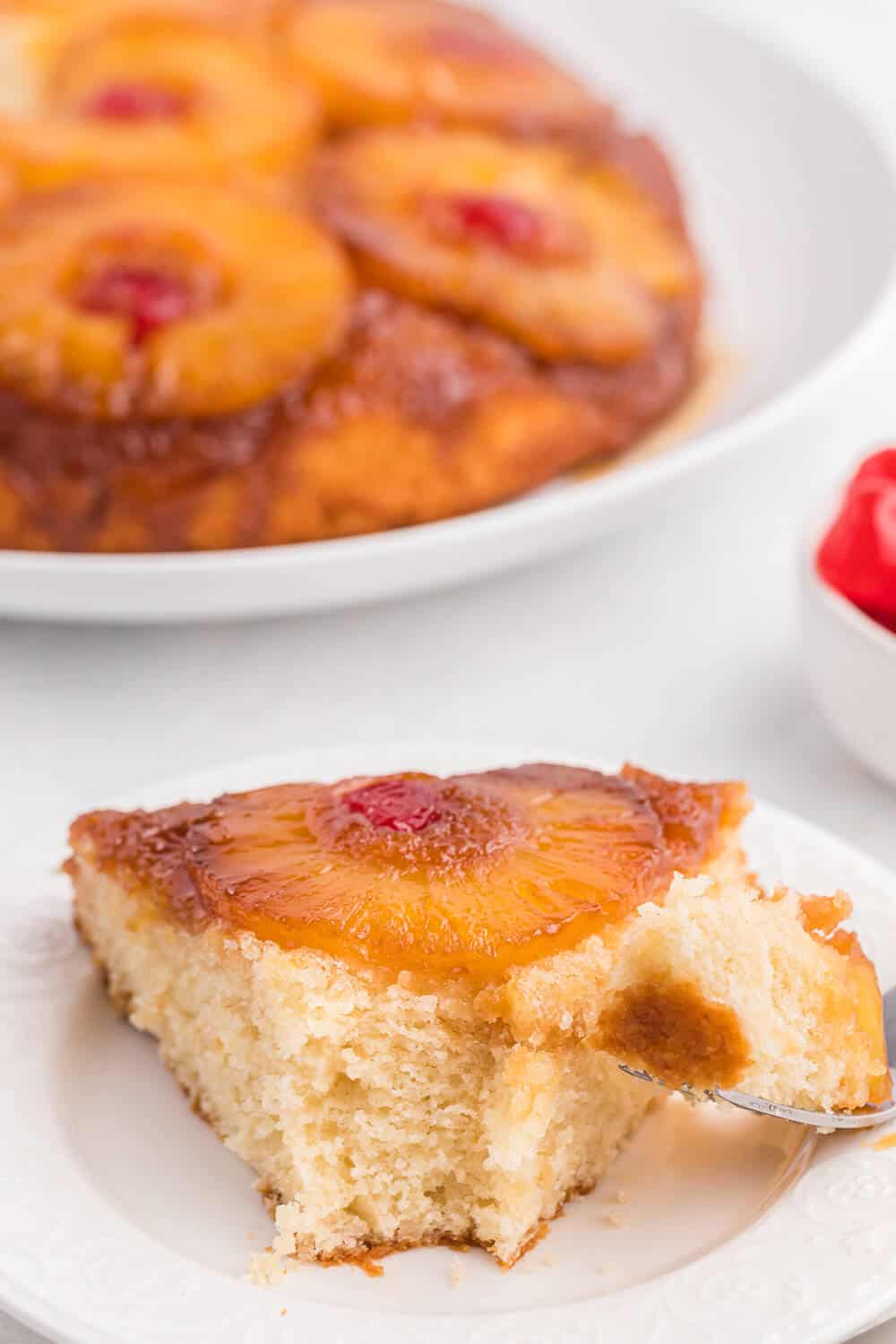 Pineapple upside down cake slice with a bite out of the end