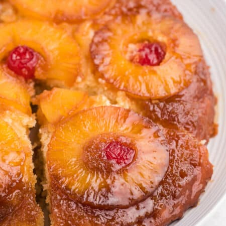 Pineapple upside down cake with a slice out of it