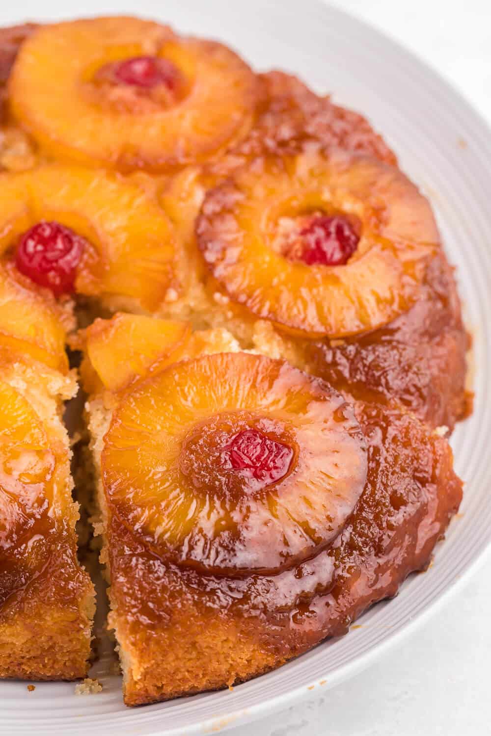 Pineapple upside down cake with a slice out of it