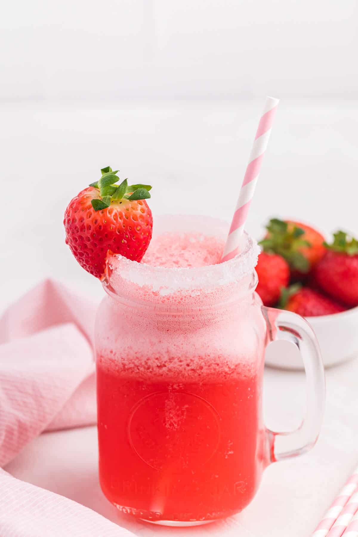 Pretty in pink punch in a mug with a straw.