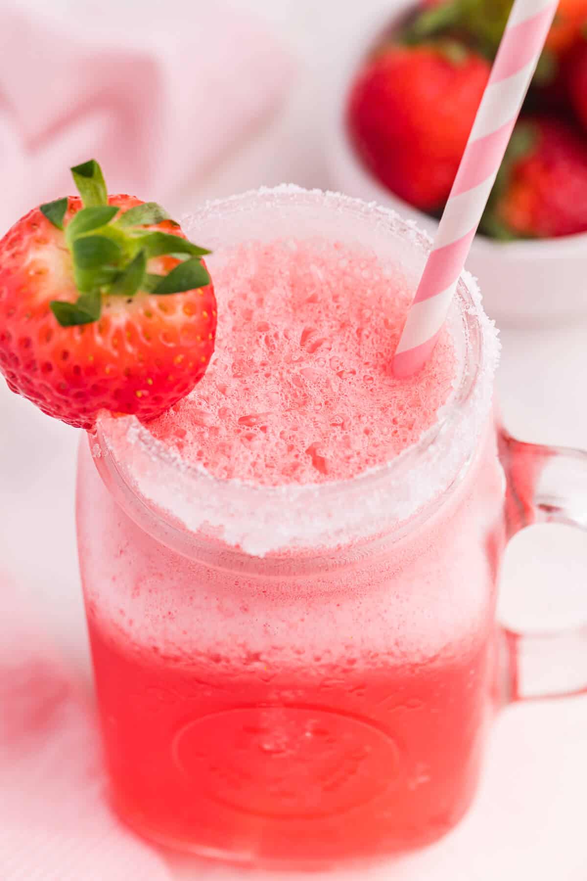 Pretty in pink punch in a glass mug.