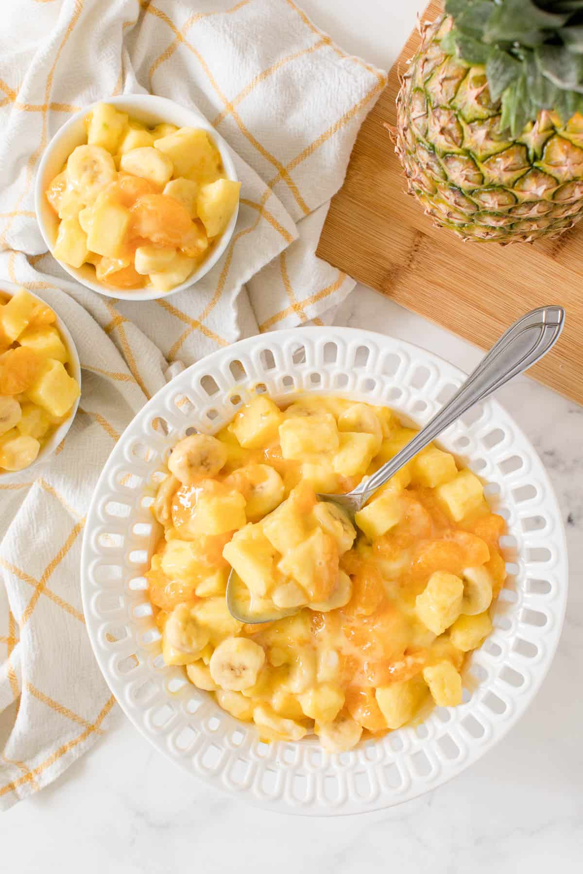 Sunshine Salad in a white bowl with a serving spoon.