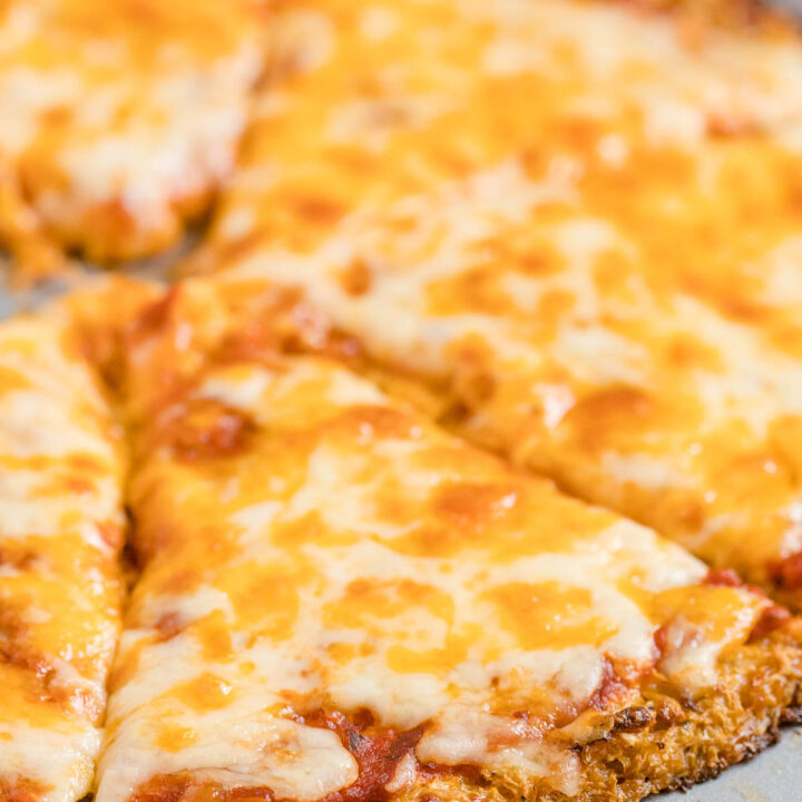 Cauliflower Pizza Crust - Perfect for keto and low-carb diets! This crispy crust is made from veggies and cheese and topped with your favorite pizza toppings.