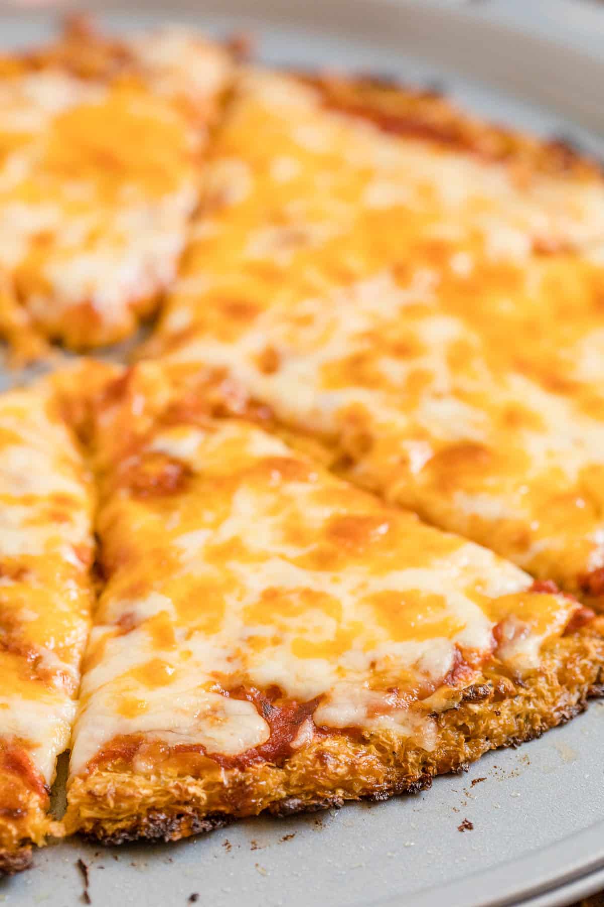 close up  photo of cauliflower crust pizza with cheese.