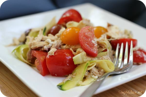 Creamy Zucchini "Pasta" with Tomato - Ditch the carbs with this keto-friendly recipe! These zoodles are fresh and light with tomatoes, shredded chicken, goat cheese, and balsamic vinegar. Perfect for cookouts.