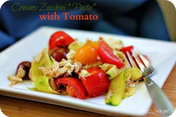 Creamy Zucchini "Pasta" with Tomato - Ditch the carbs with this keto-friendly recipe! These zoodles are fresh and light with tomatoes, shredded chicken, goat cheese, and balsamic vinegar. Perfect for cookouts.