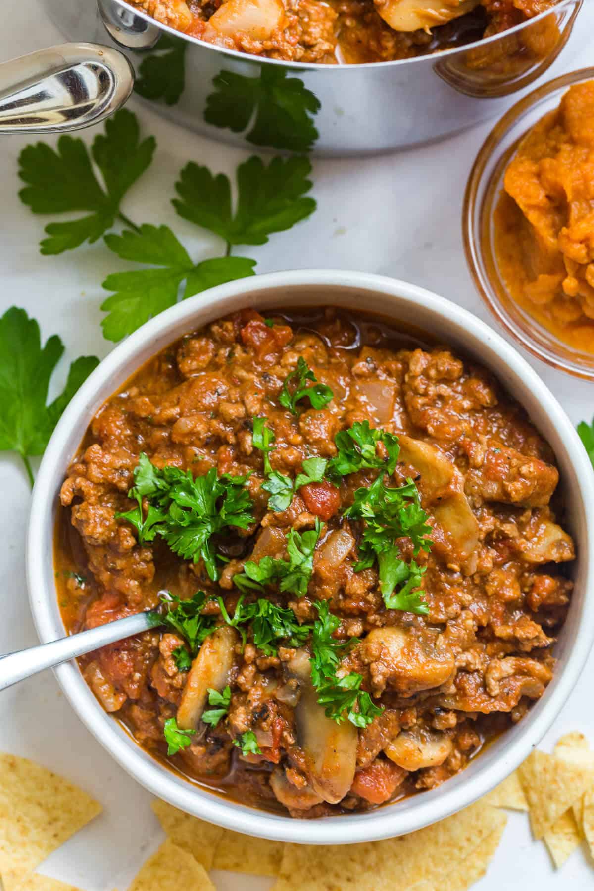 The chili in a bowl with a spoon.