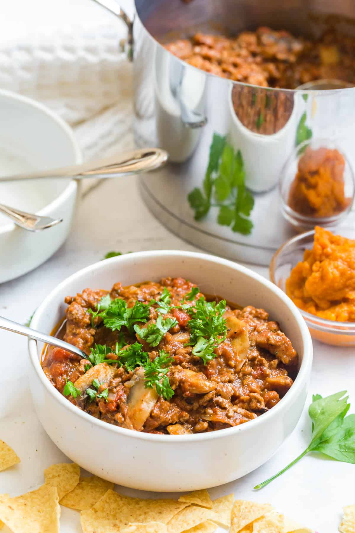 Pumpkin chili in a bowl with a spoon.