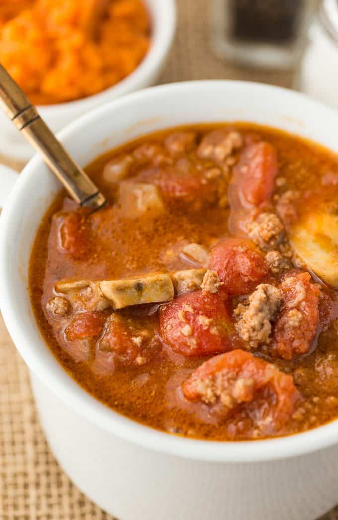 Pumpkin Chili - The best fall chili recipe! This savory and filling soup recipe is perfect for tailgating with pumpkin, ground beef, mushrooms, and tomatoes, too.