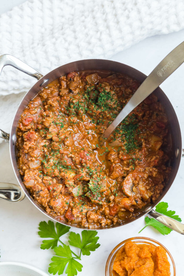 Pumpkin chili in a pot with a ladle.