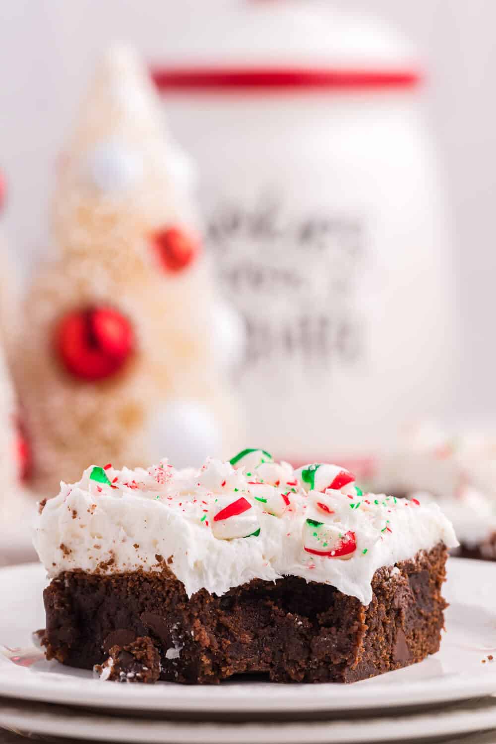 a candy cane brownie on a plate with a bite out of it