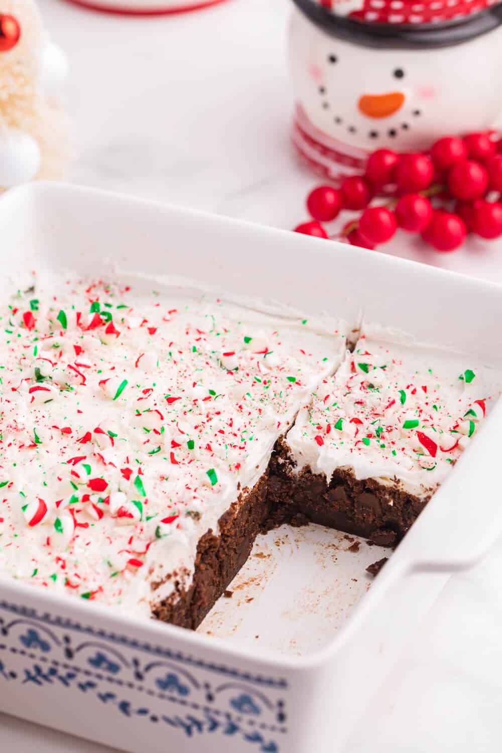 candy cane brownies in a casserole pan with pieces cut from it