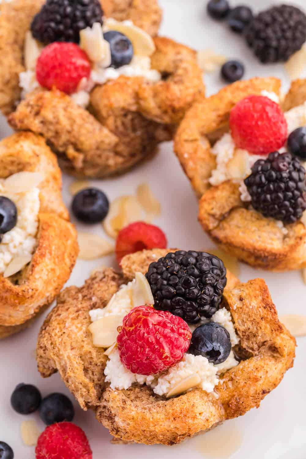 French Toast Cups - This easy breakfast recipe is the perfect sweet start to your day. Creamy ricotta with fresh berries and a drizzle of honey or maple syrup are a delicious breakfast treat.