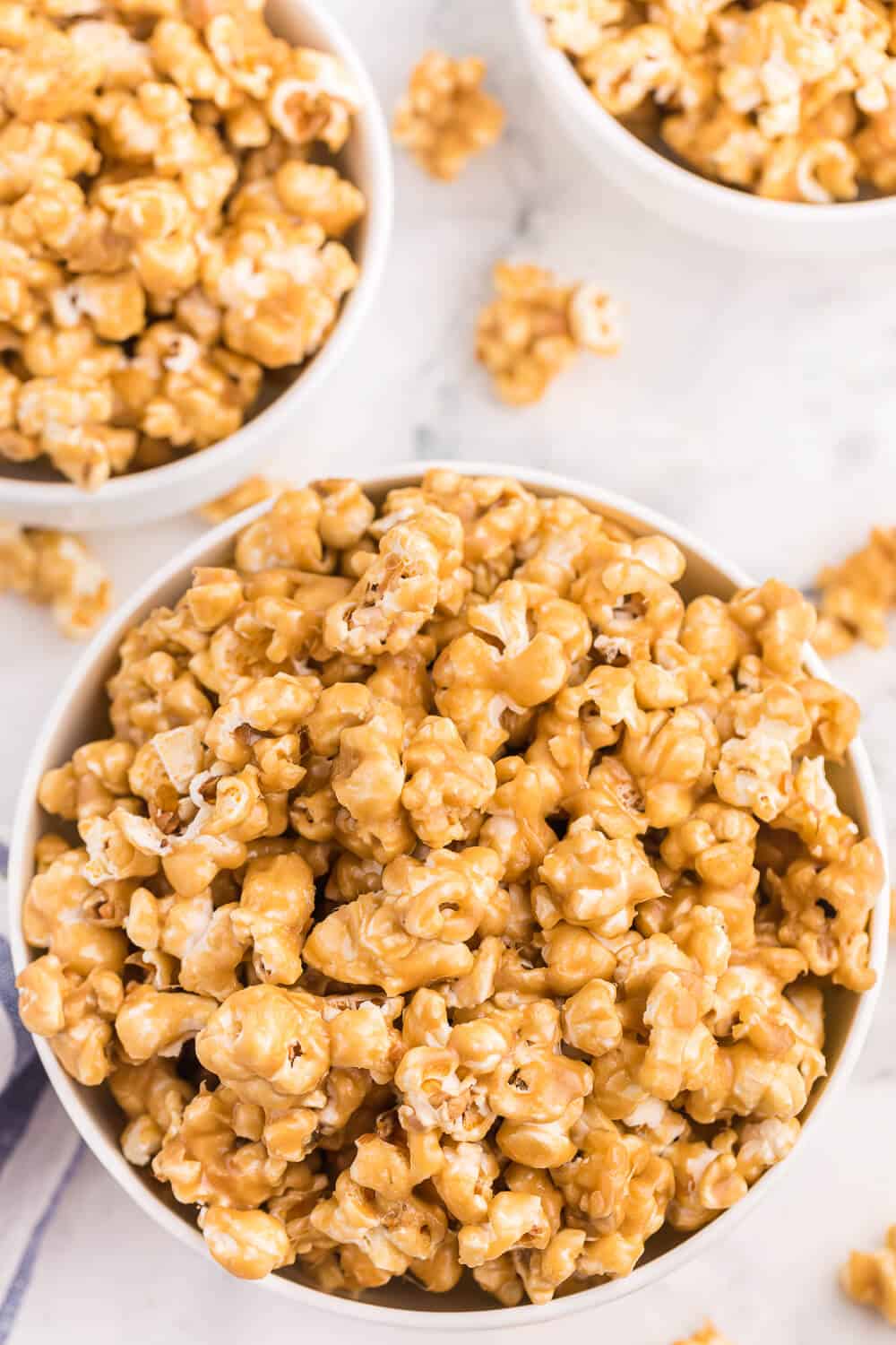 three bowls of caramel marshmallow popcorn