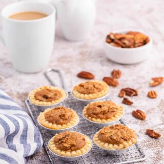 Pecan butter tarts on a wire rack.