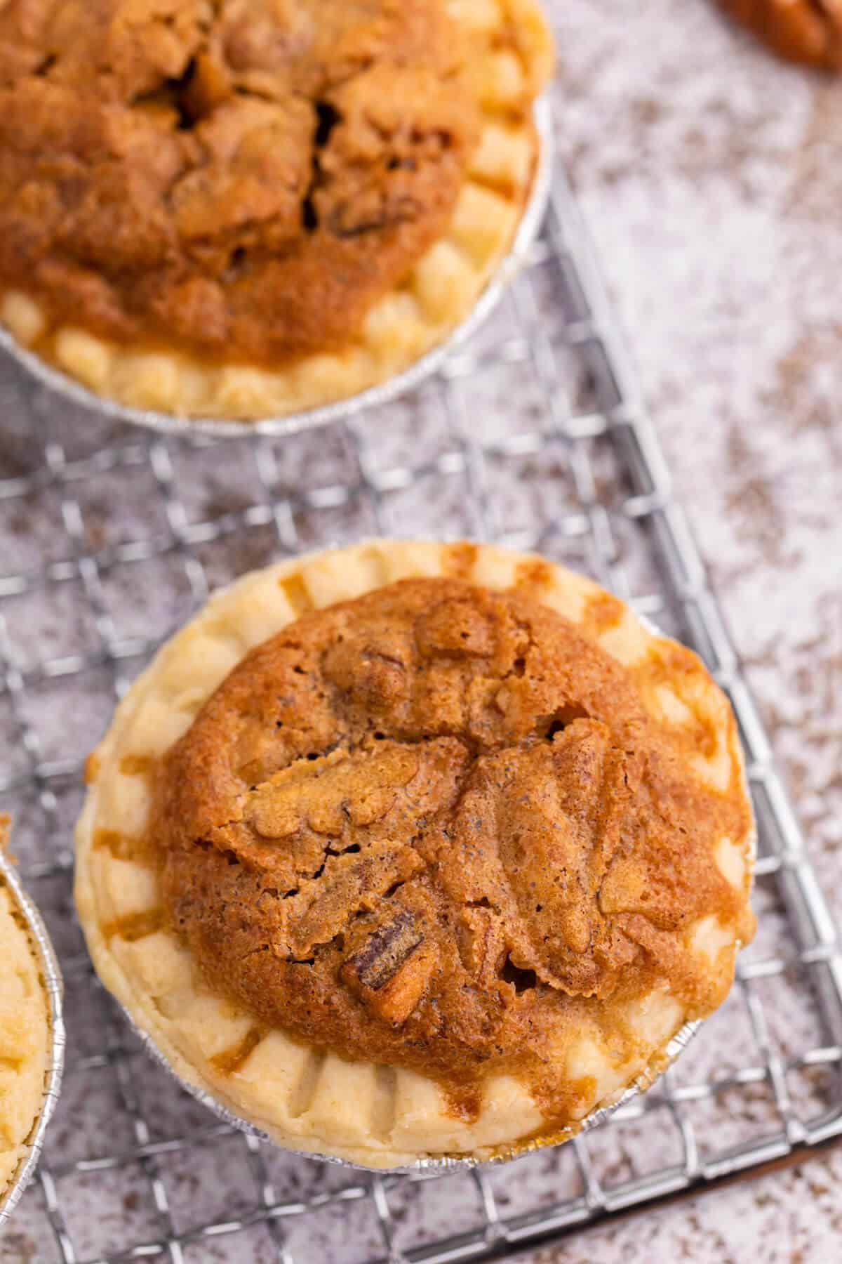 Pecan butter tart on a wire rack.