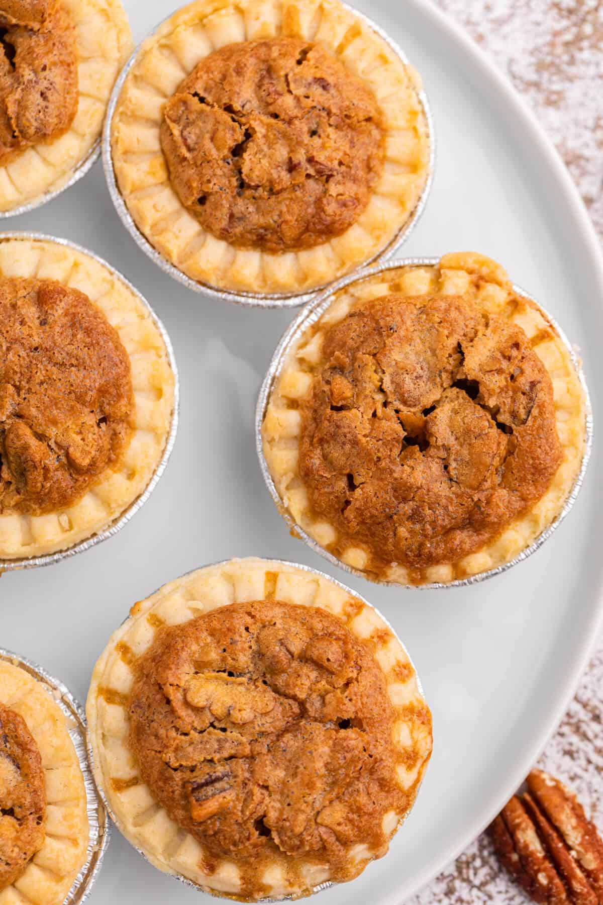 Pecan butter tarts on a plate.