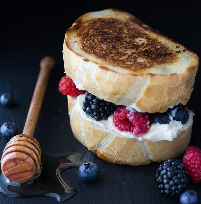 Dessert Grilled Cheese Sandwiches - Not your typical grilled cheese sandwich! It's filled with creamy mascarpone cheese, fresh sweet berries and a drizzle of honey. 