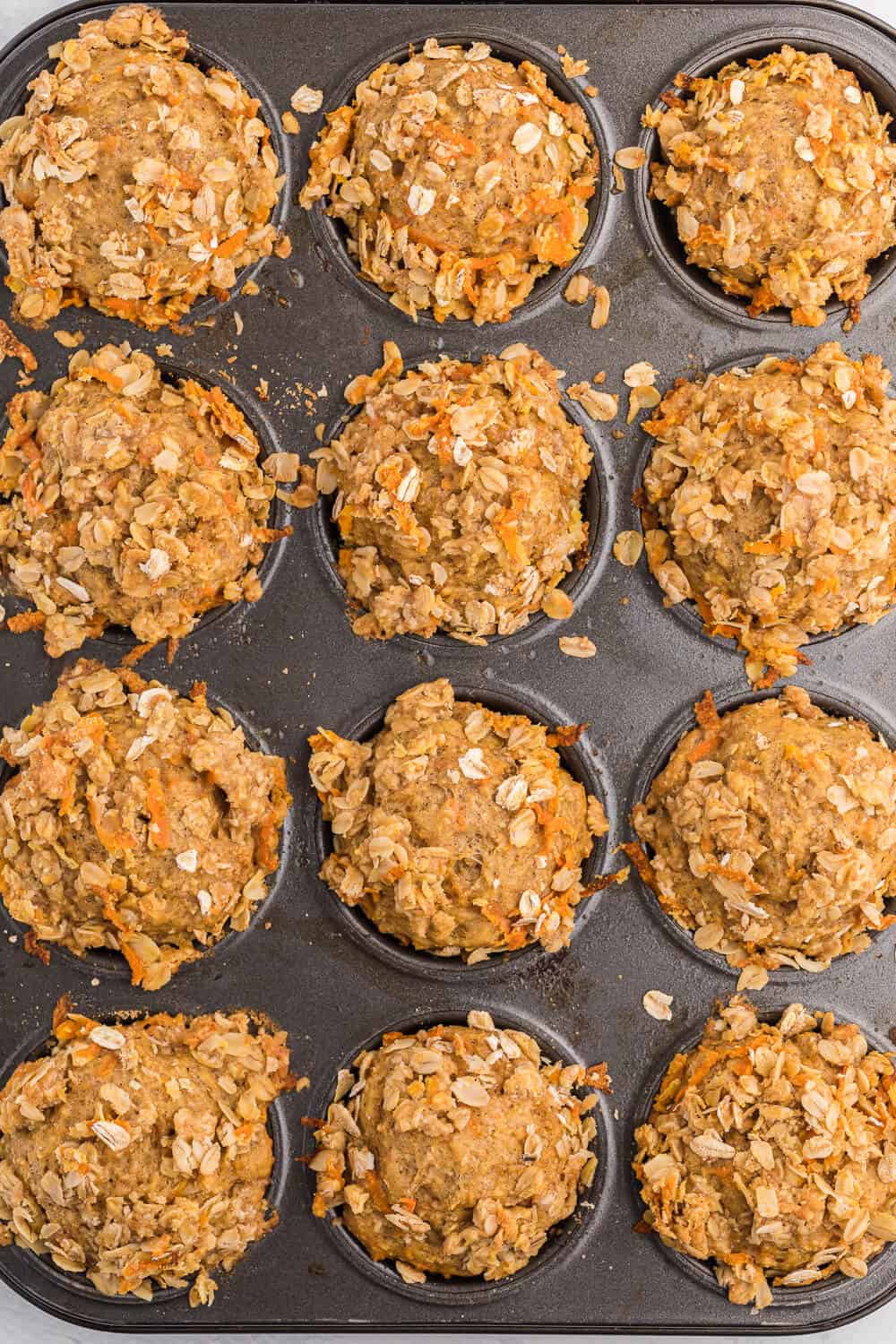 Double Orange Muffins - Packed full of goodness with carrots, orange juice, oat bran, flax seed, Greek yogurt and more. Make the night before to save time in the morning. Healthy and delicious!