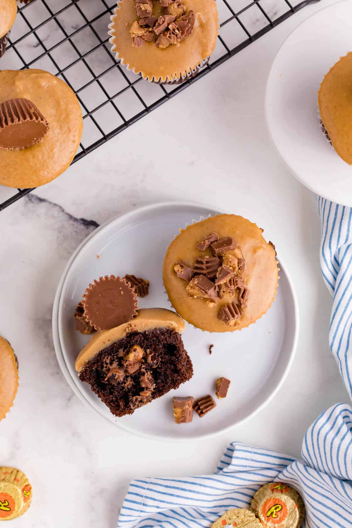 A Reese's Cupcake cut in half on a plate.