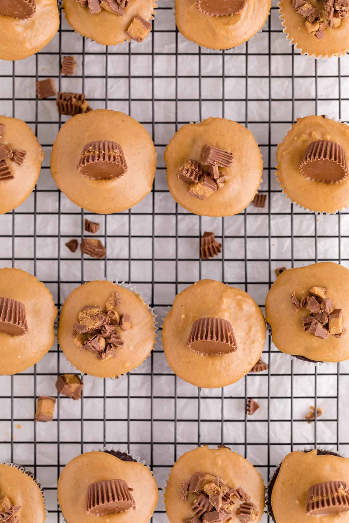 Reese's cupcakes on a wire rack.