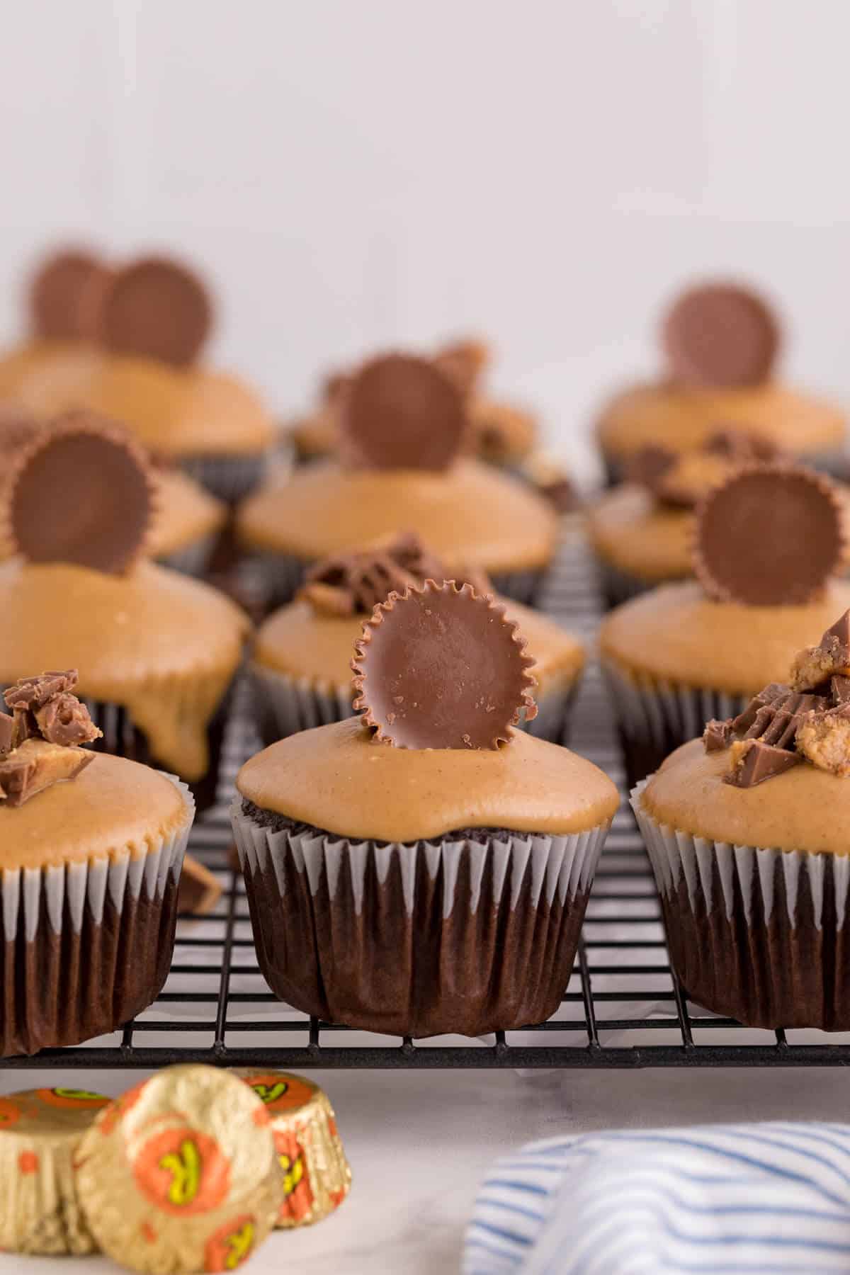 Reese's cupcakes on a wire rack.