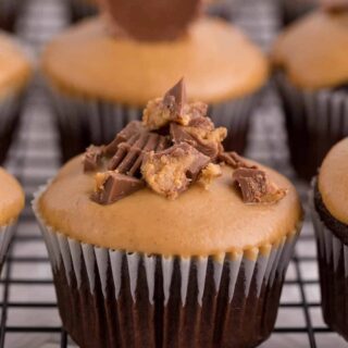 Reese's cupcakes on a wire rack.