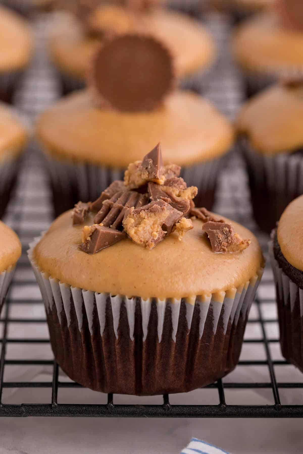 Reese's cupcakes on a wire rack.