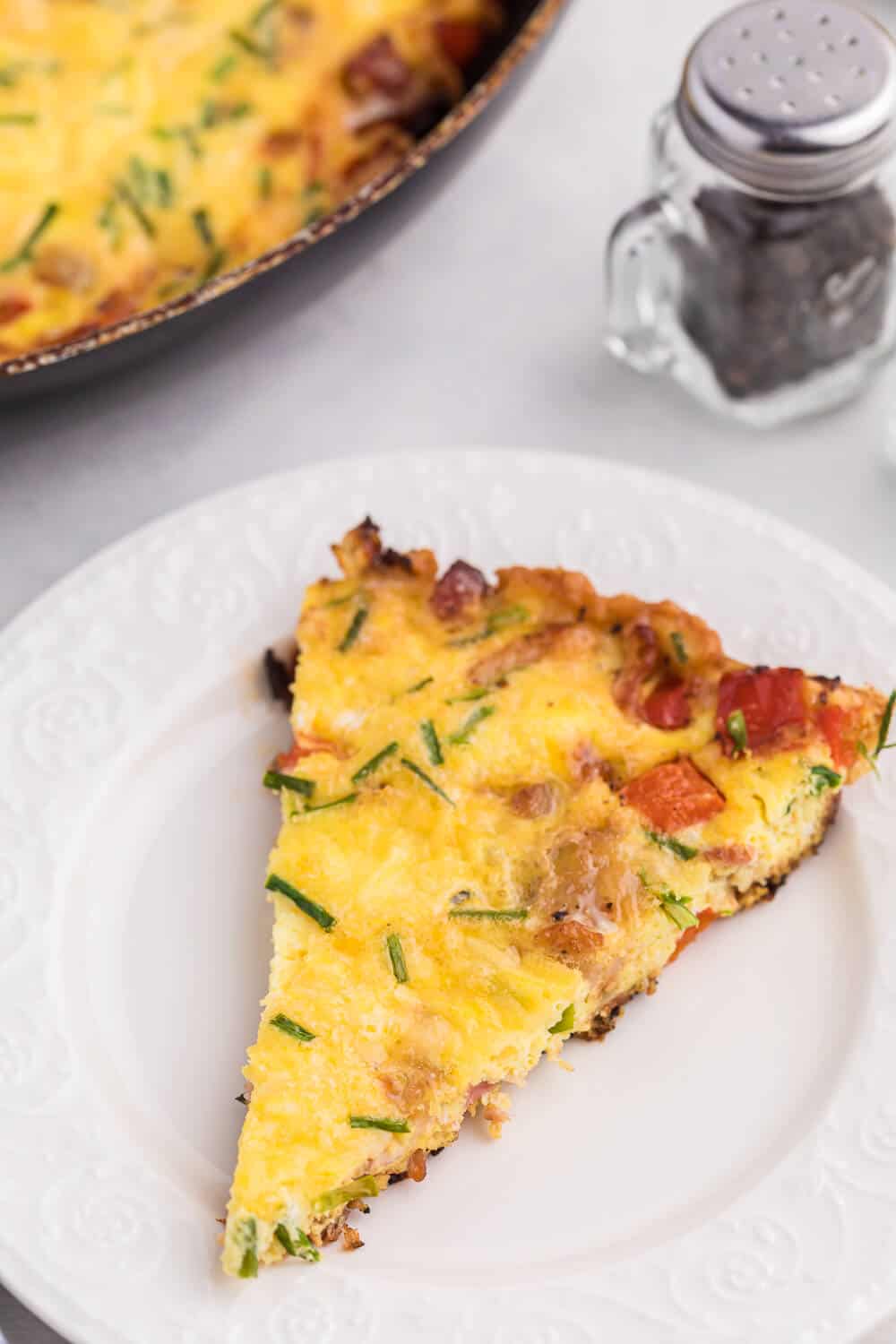 Bacon and Gouda Frittata - This breakfast/brunch recipe is a sophisticated twist on traditional bacon and eggs! Including gouda, chives and shallots, these elegant ingredients make this quick and easy meal seems like a special occasion.